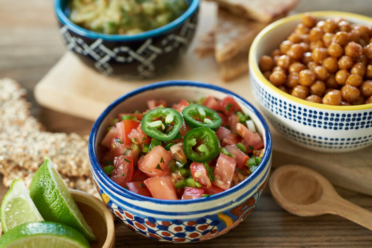 3/4 overhead view of salsa fresca in a colorful bowl.