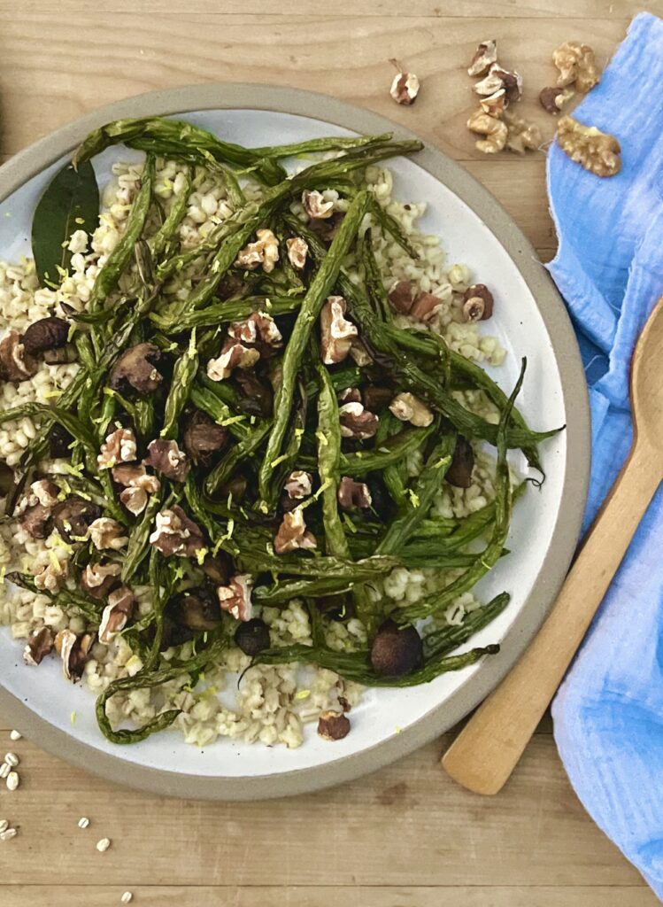 Overhead picture of roasted green beans and mushrooms over top of a bed of toasted barley.