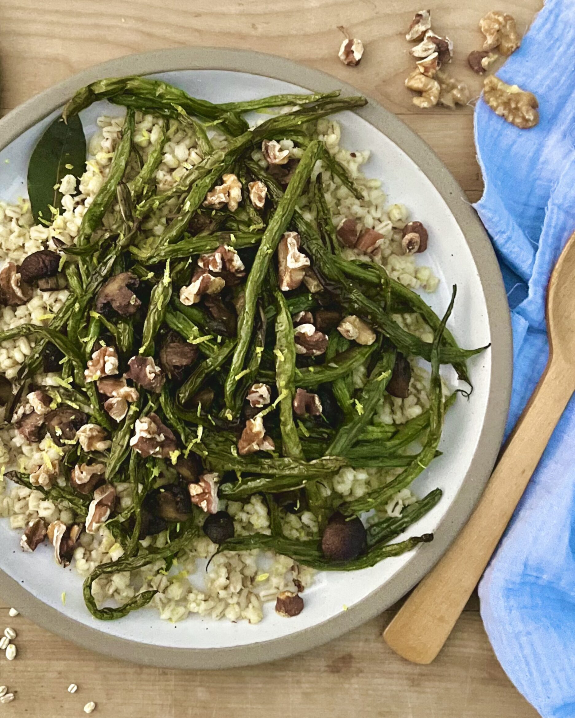 Overhead picture of roasted green beans and mushrooms over top of a bed of toasted barley.