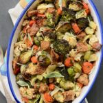 Overhead view of a large white bowl with a blue rim filled with the roasted vegetable stuffing.